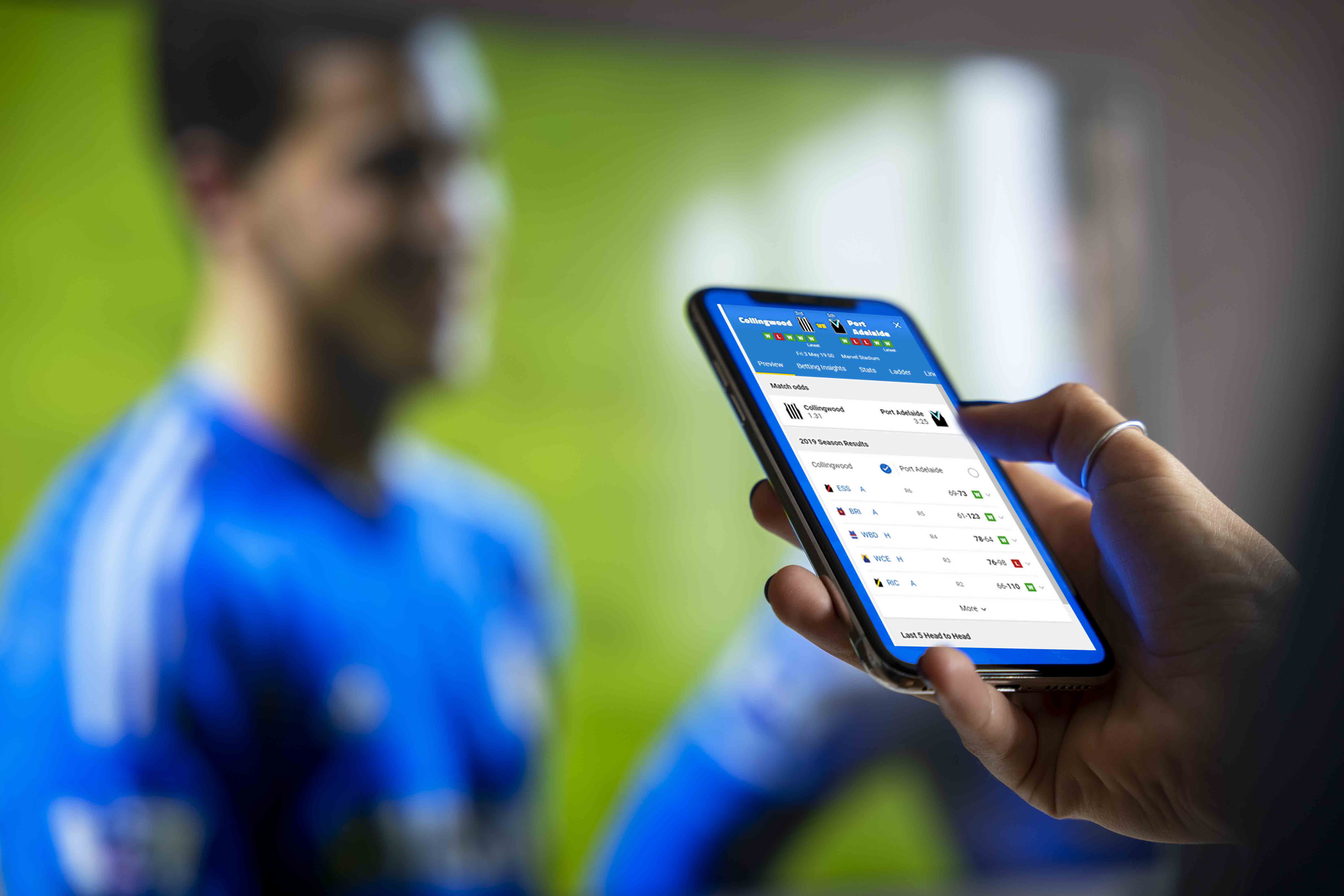 A person checking match odds on a phone